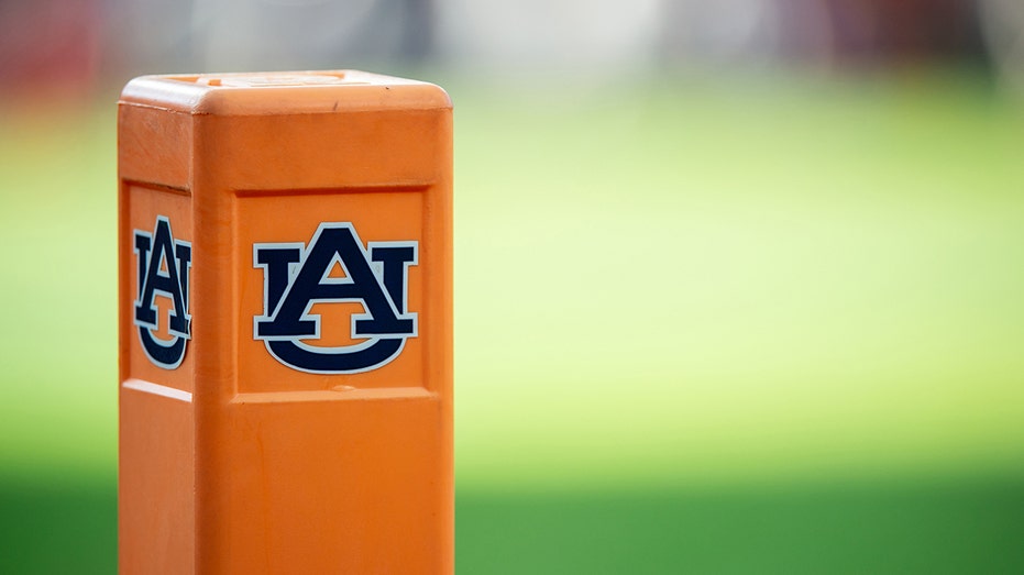  Auburn cheerleader knocks down Oklahoma player running onto field while performing stunts 