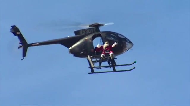  Santa swoops in on chopper for bike and toy giveaway at Sweetwater park 