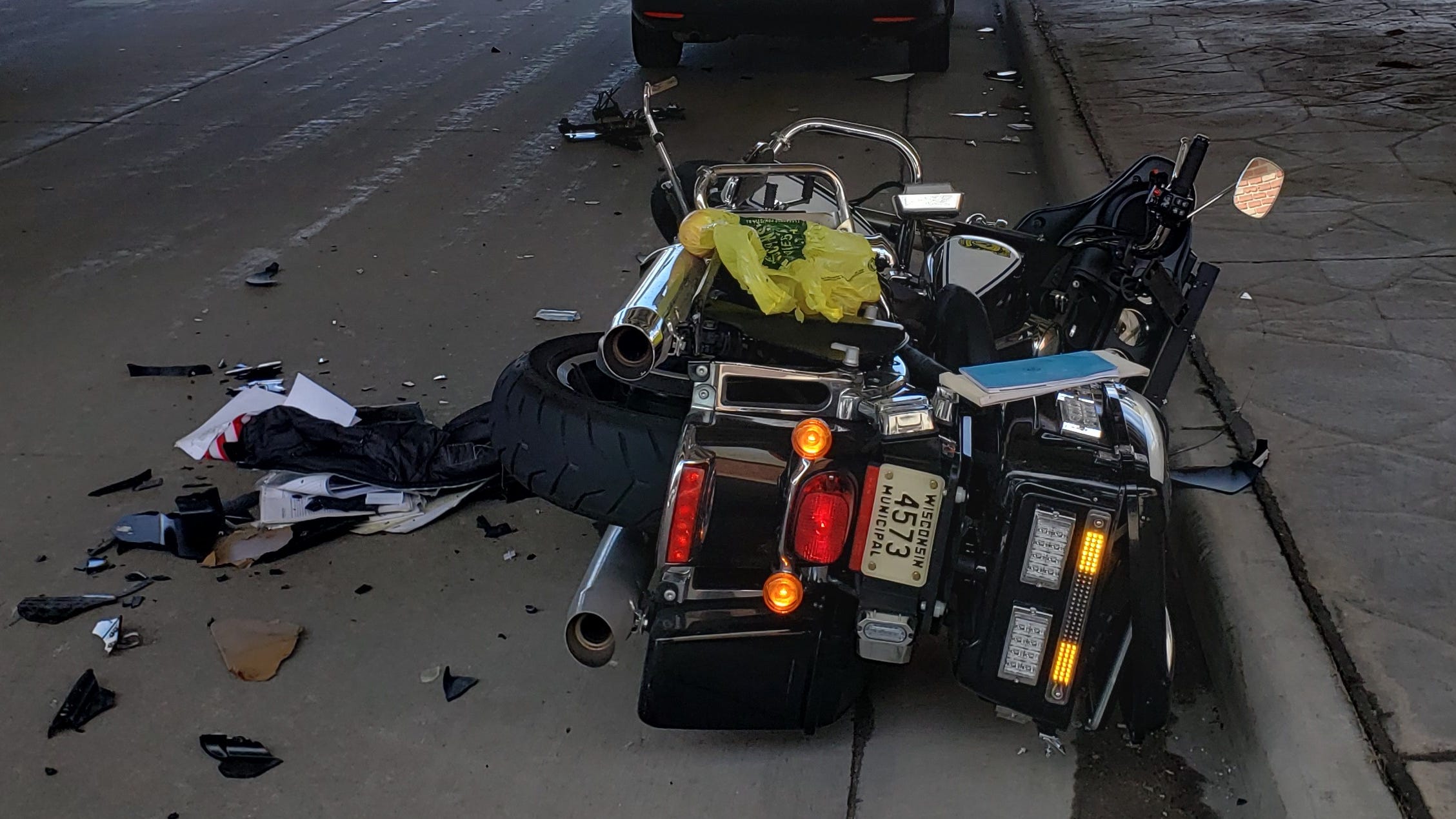  Green Bay police officer writing a ticket escapes serious injury when passing car crashes into his motorcycle 