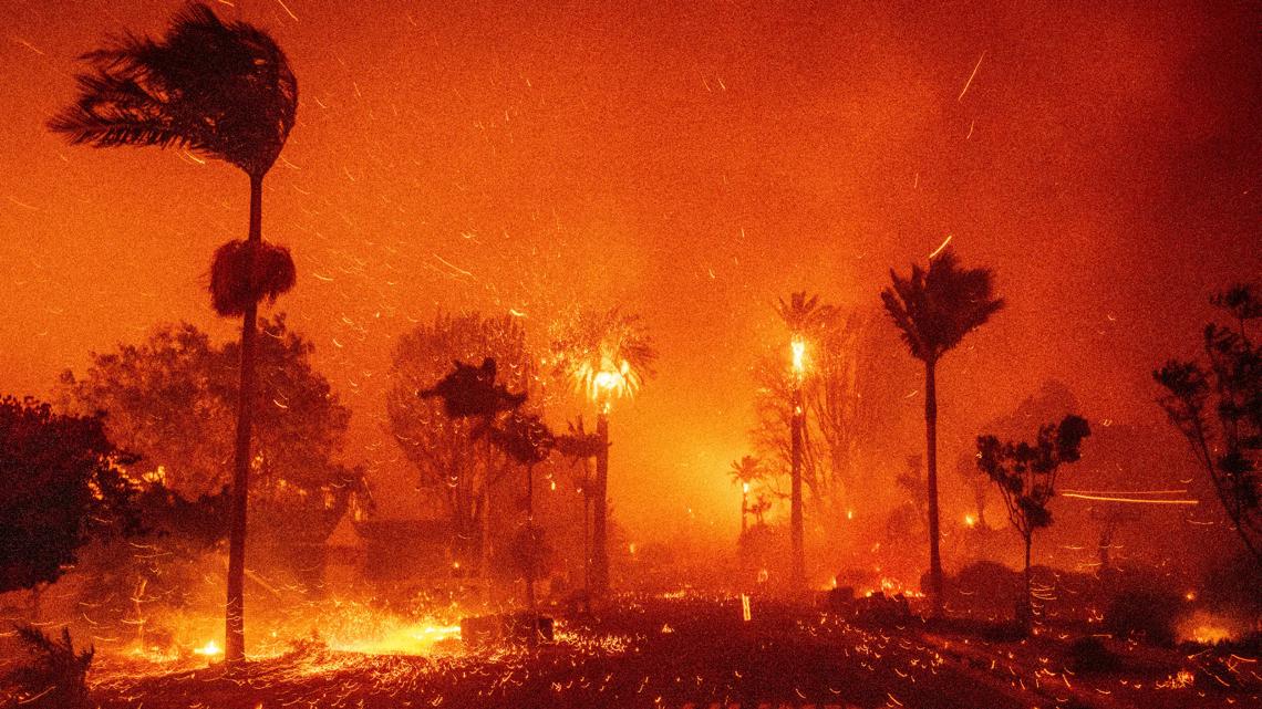  Thousands flee as wildfires burn out of control in and around Los Angeles and homes are destroyed 